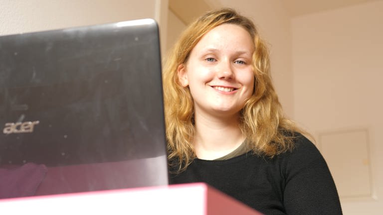 Rebecca - eine junge Frau sitzt vor Laptop